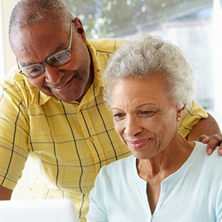 Mature couple using laptop.